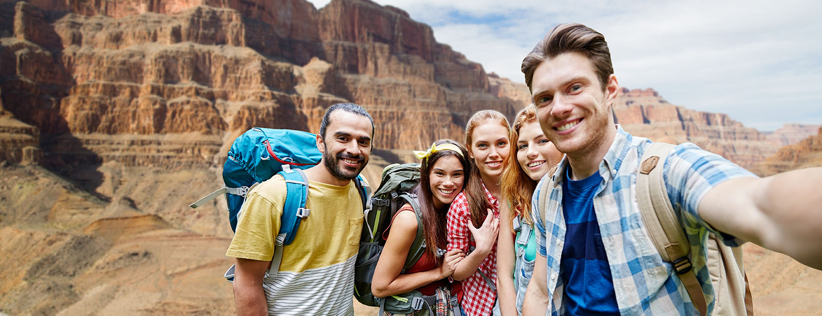 Five friends backpacking in canyons