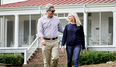 Man and woman walking on andalusia farm.