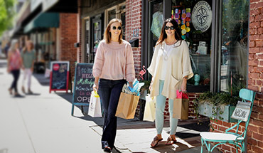 Young ladies walking downtown shopping.