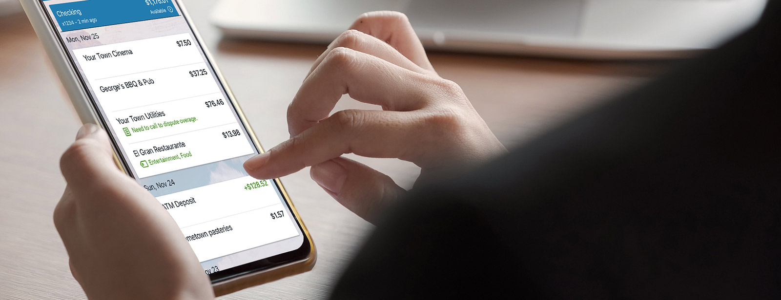 Woman holding phone doing banking.