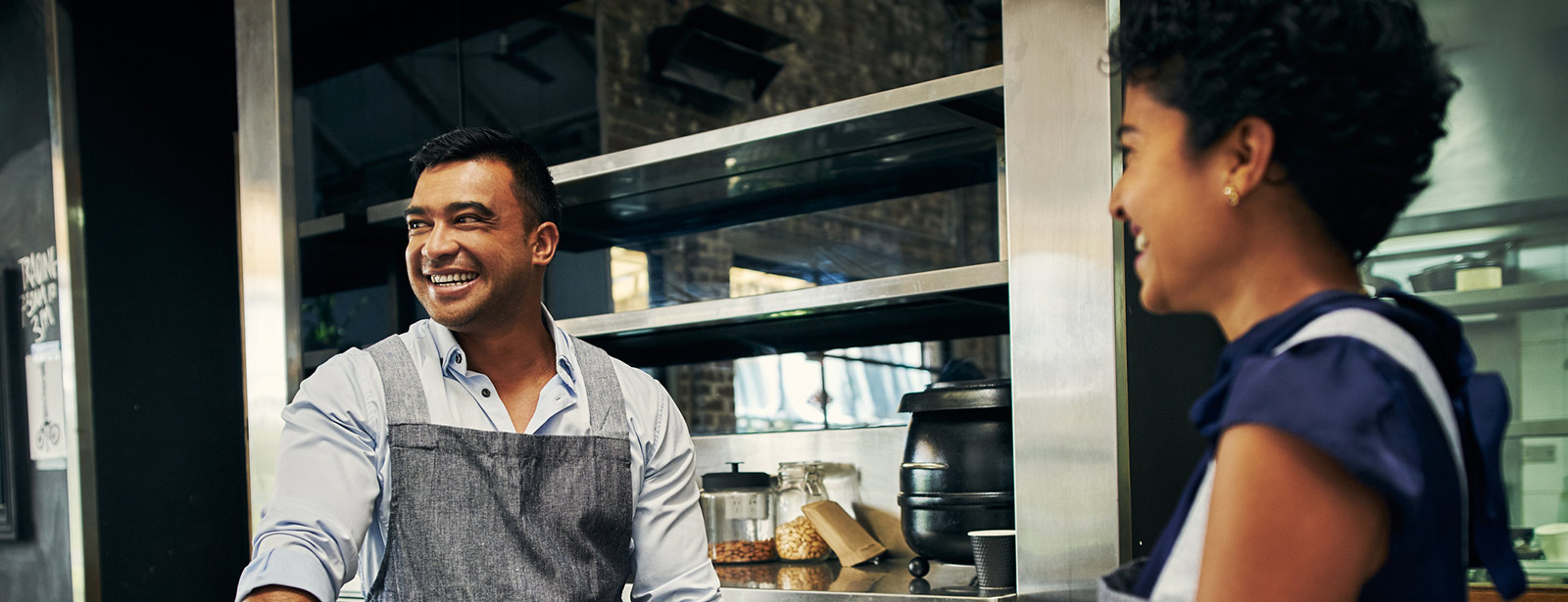 Two people in commercial kitchen.