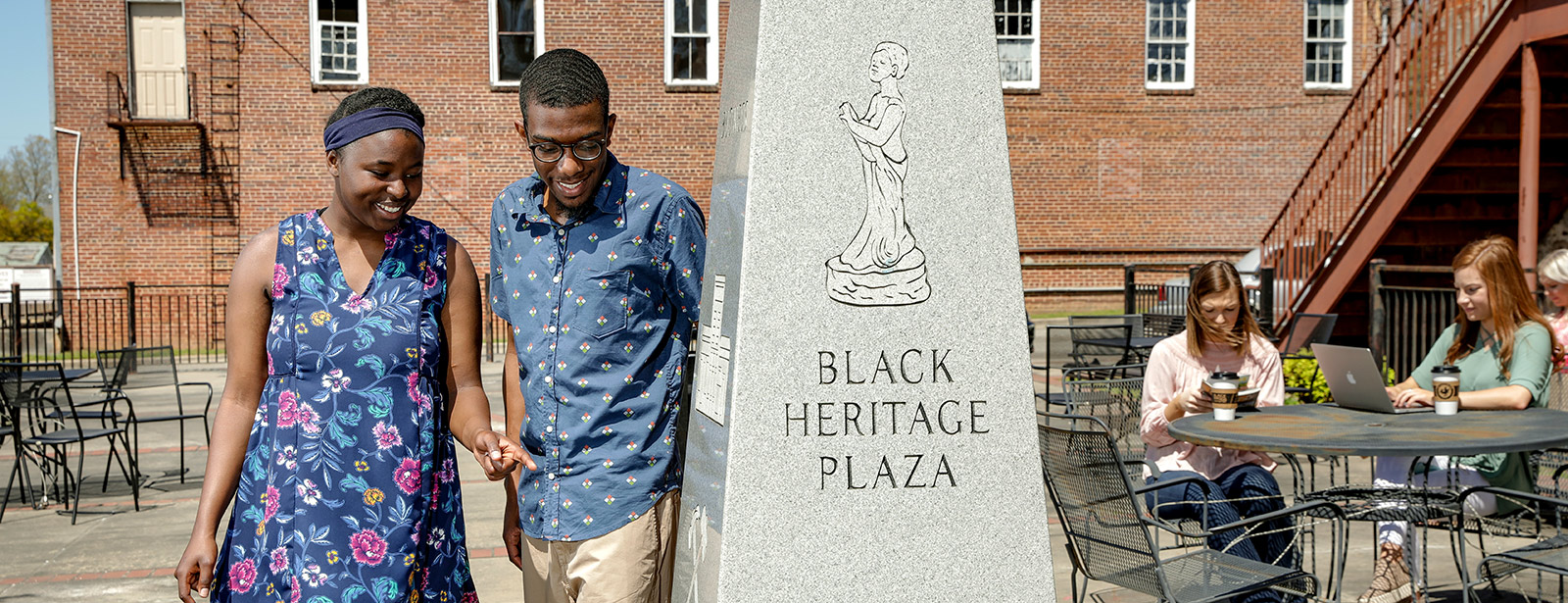 Couple walking through plaza.